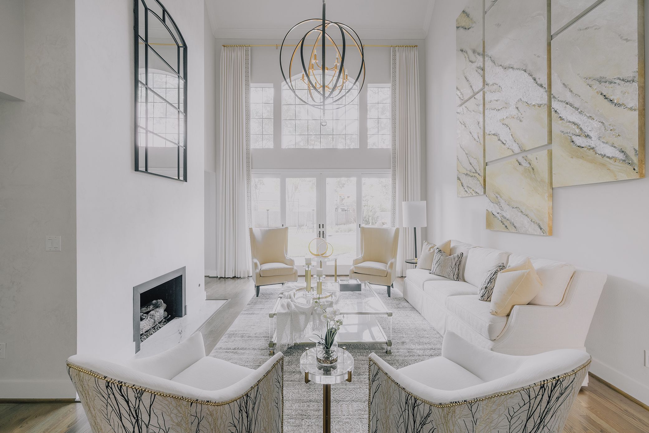 Effortless by Brooke - Decorating Den Interiors white living room with tall windows and modern fireplace.
